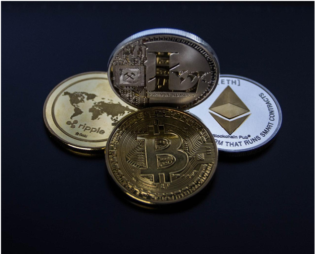 four assorted cryptocurrency coins